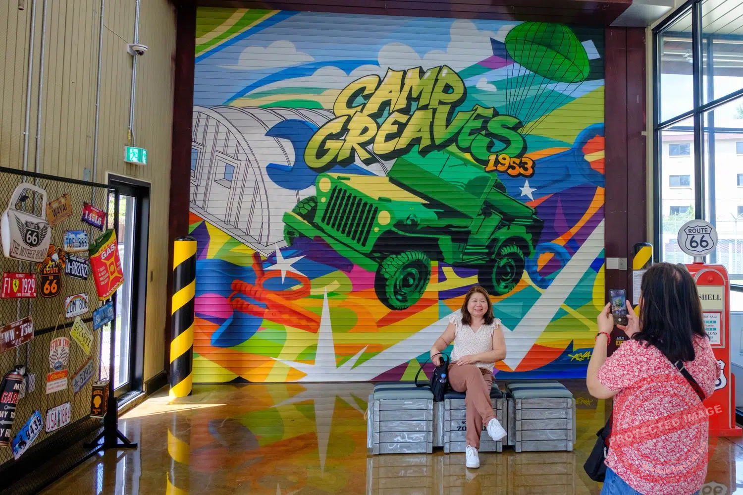 dmz-camp-greaves-15 Tourists take photos in the former vehicle repair shop at Camp Greaves, which has been converted into a café (September 2025).