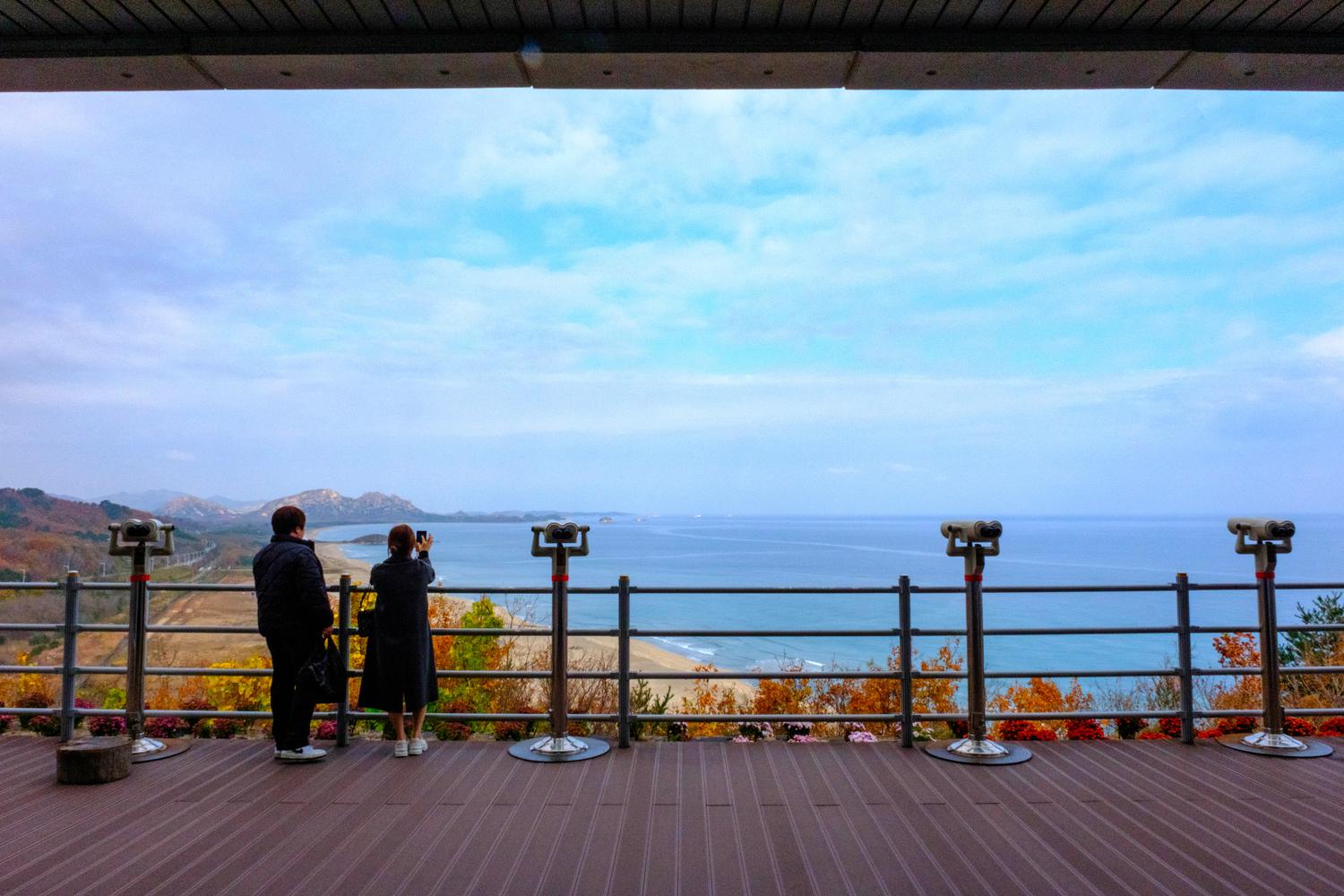 A couple watches the Sea of Japan and the coast of North Korea from the Goseong Observatory (November 2025).
