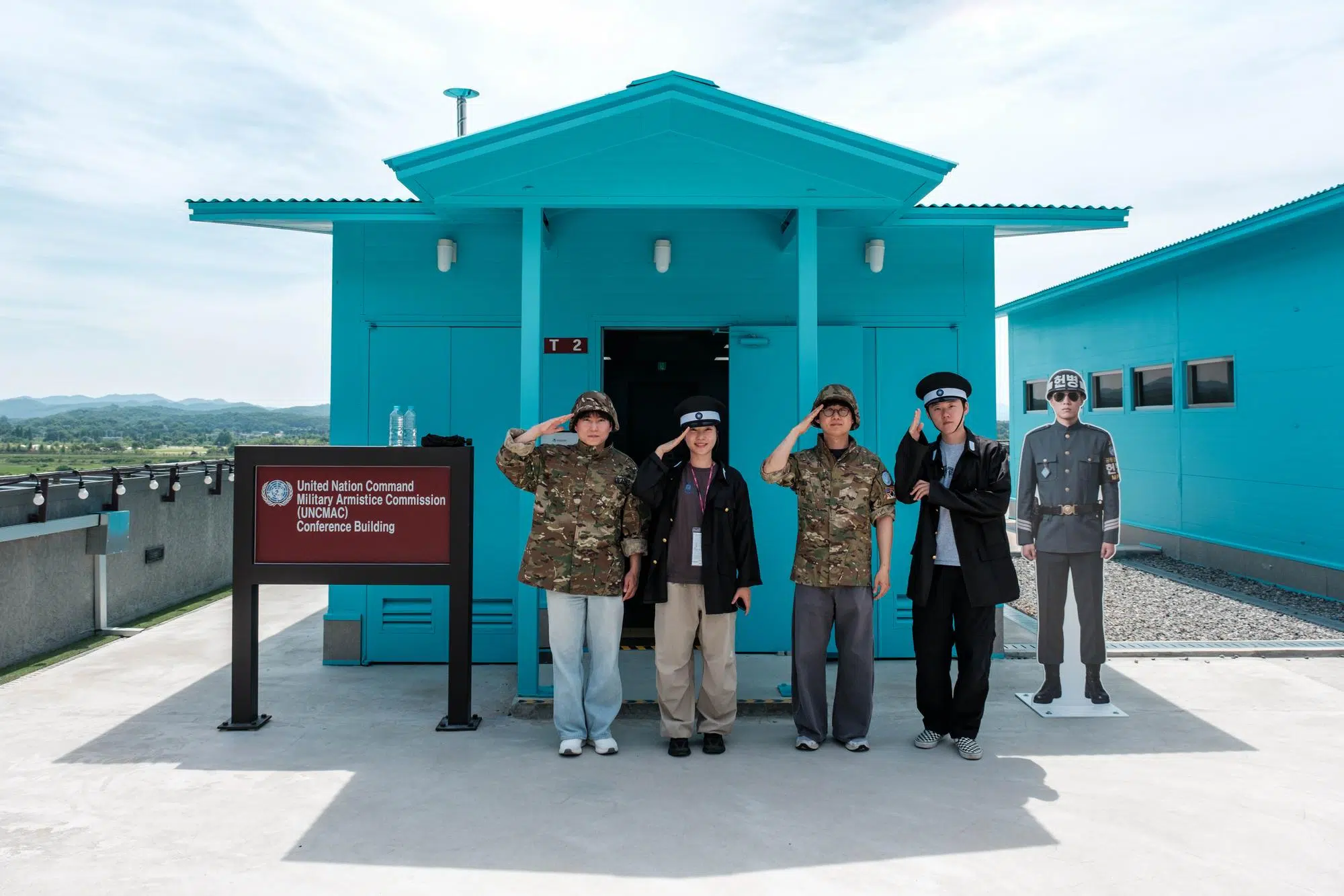 imjingak-jsa-imitation-tourists Tourists pose in front of a scale model of the conference huts in the Joint Security Area at Imjingak (June 2026).
