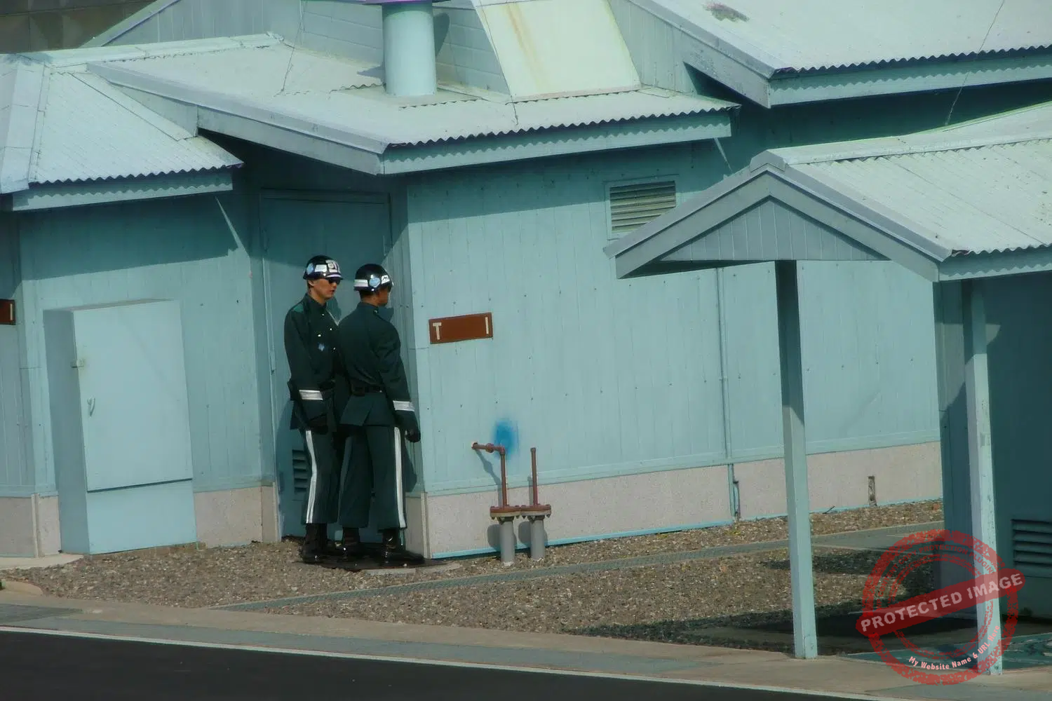 jsa-panmunjom-008-upscaled Soldiers from the United Nations Command stand guard behind one of the blue huts of the Joint Security Area