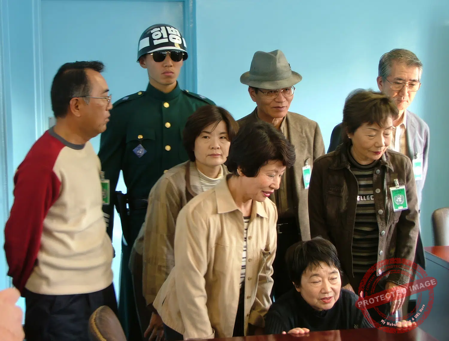jsa-panmunjom-hut-2005 Japanese tourists visit one of the JSA's conference rooms straddling the demarcation line. Guarded by a South Korean soldier, the back door opens directly onto North Korea (November 2005).