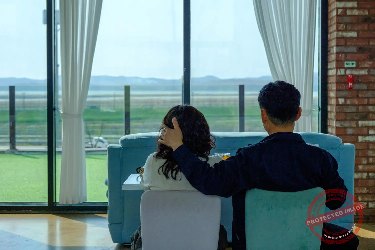 looking-north-00007 A couple watches the North Korean landscape from Daon Forest Cafe's lounge in Paju (April 2025).