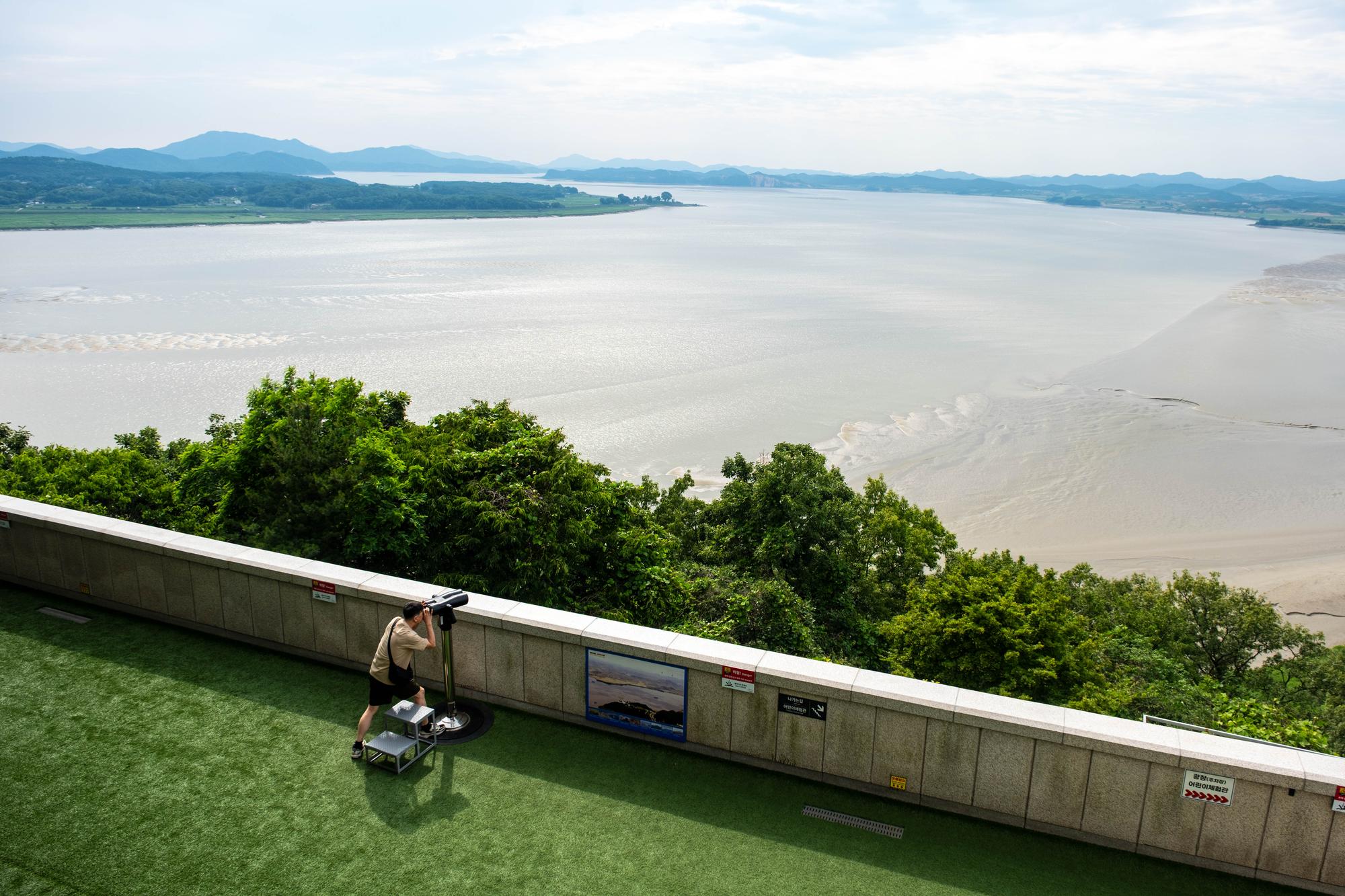 odusan-observatory-june-2026-4 A tourist watches North Korea through a telescope from Odusan Observatory in Paju.