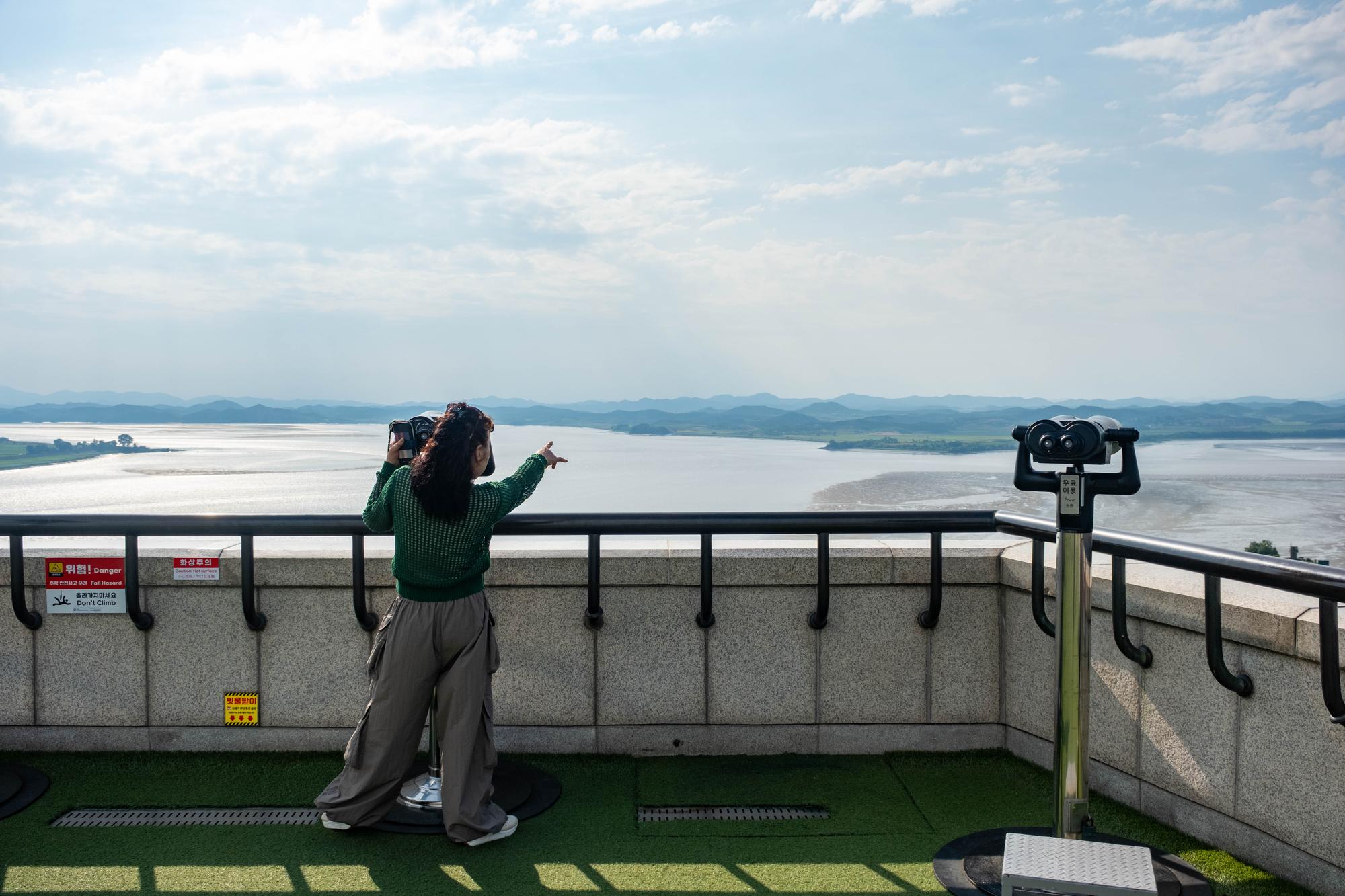 odusan-observatory-june-2026-9 A tourist watches North Korea through a telescope from Odusan Observatory in Paju.