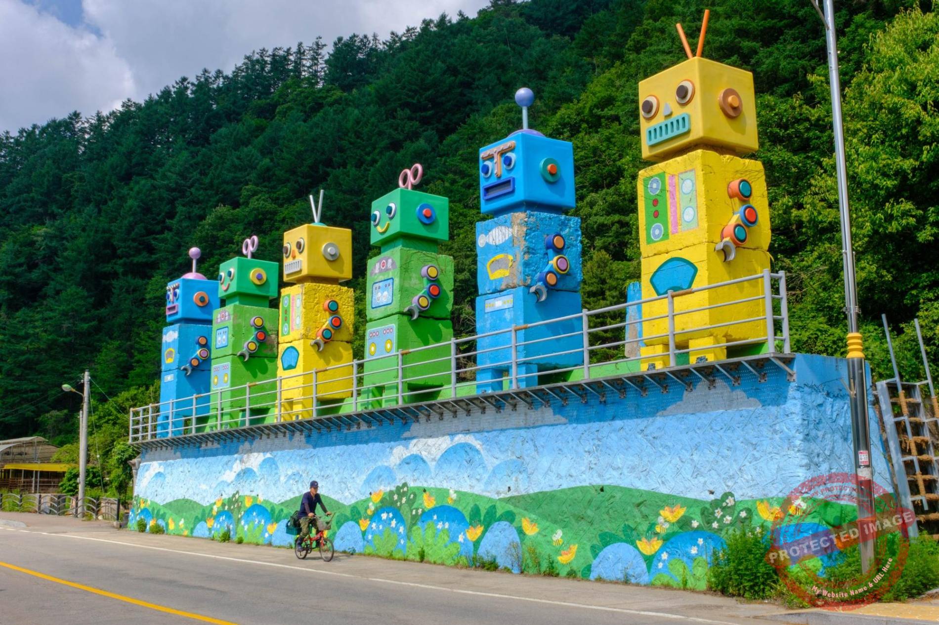 abductees-memorial-names A cyclist passes by an imaginatively decorated anti-tank obstacle in a village near Hwacheon (June 2025).