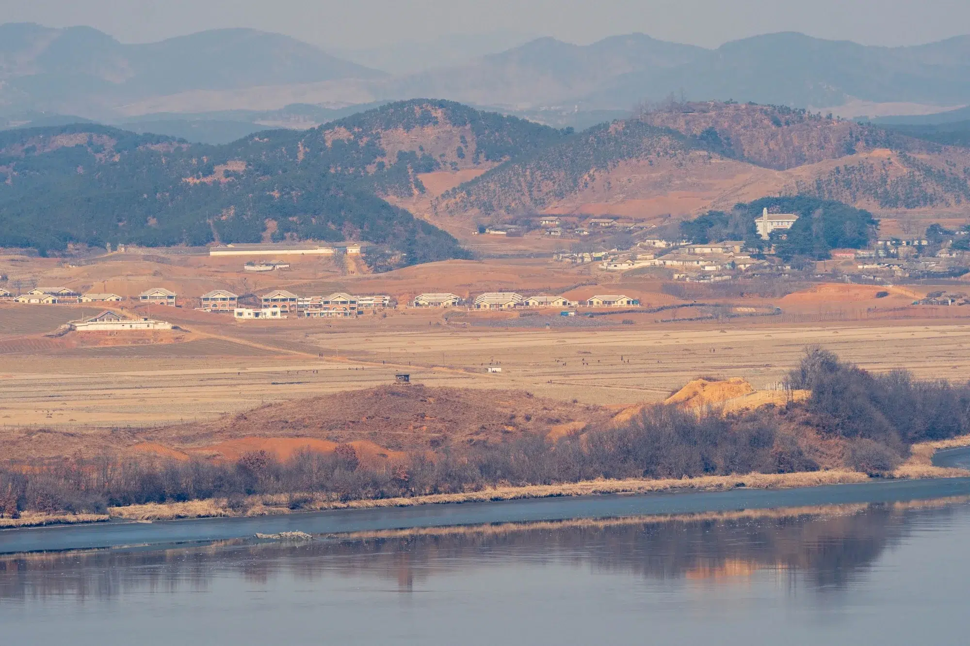 paju-jayu-ro-north-korea-farming-2025 Farm work in North Korea, as seen from the other side of the Imjin River, which runs alongside Jayu-ro (February 2025).