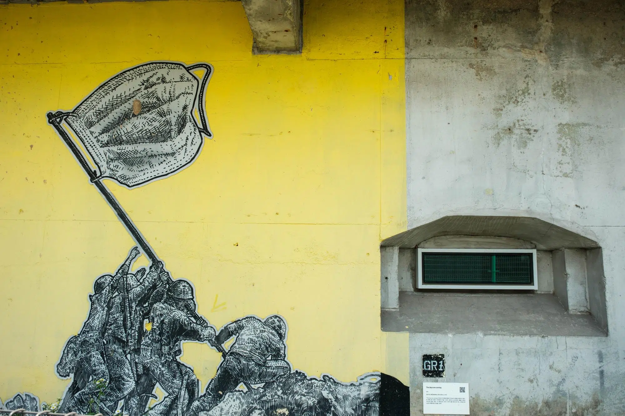 peace-culture-bunker-mural-mask A parody of “Raising the Flag on Iwo Jima” set during the COVID-19 pandemic on one of the walls of Peace Culture Bunker in Seoul.