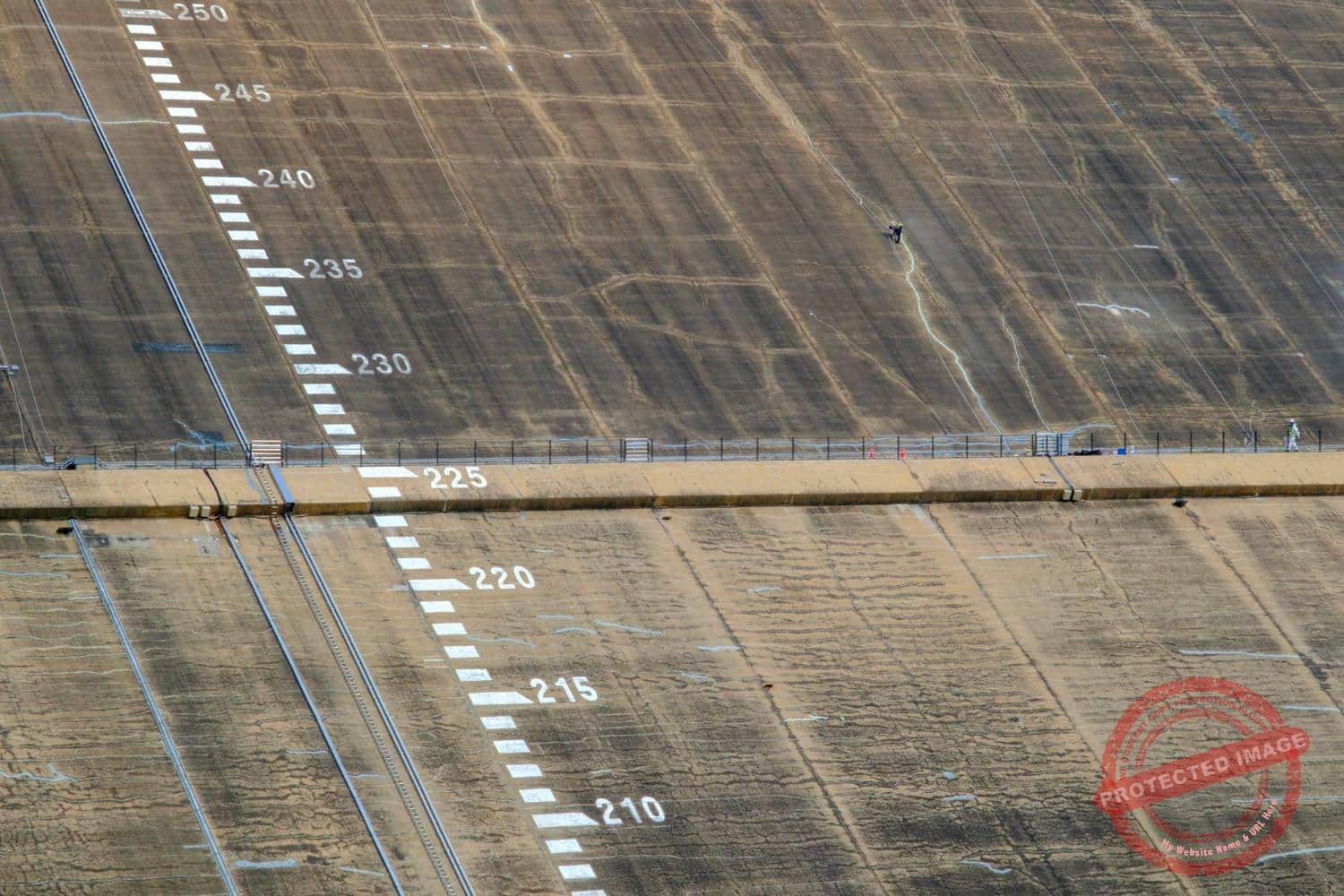 peace-dam-10 Workers carry out maintenance duties on the northern side of the dam (June 2025).