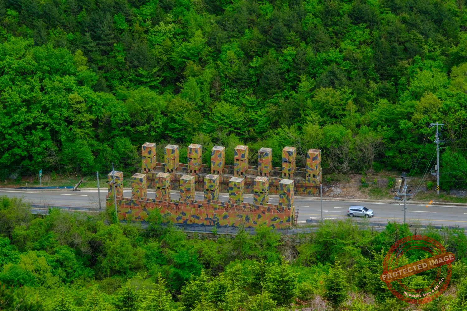 A car drives through an anti-tank obstacle in the Punchbowl basin (May 2025).