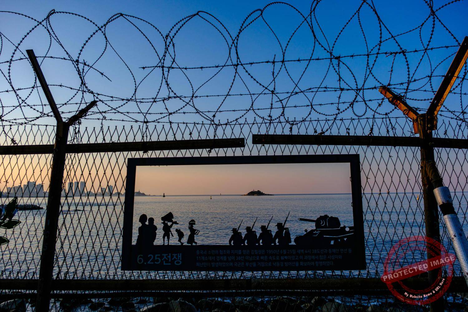 Anti-infiltrator fences and CCTV cameras along a coastal path in the City of Sokcho.