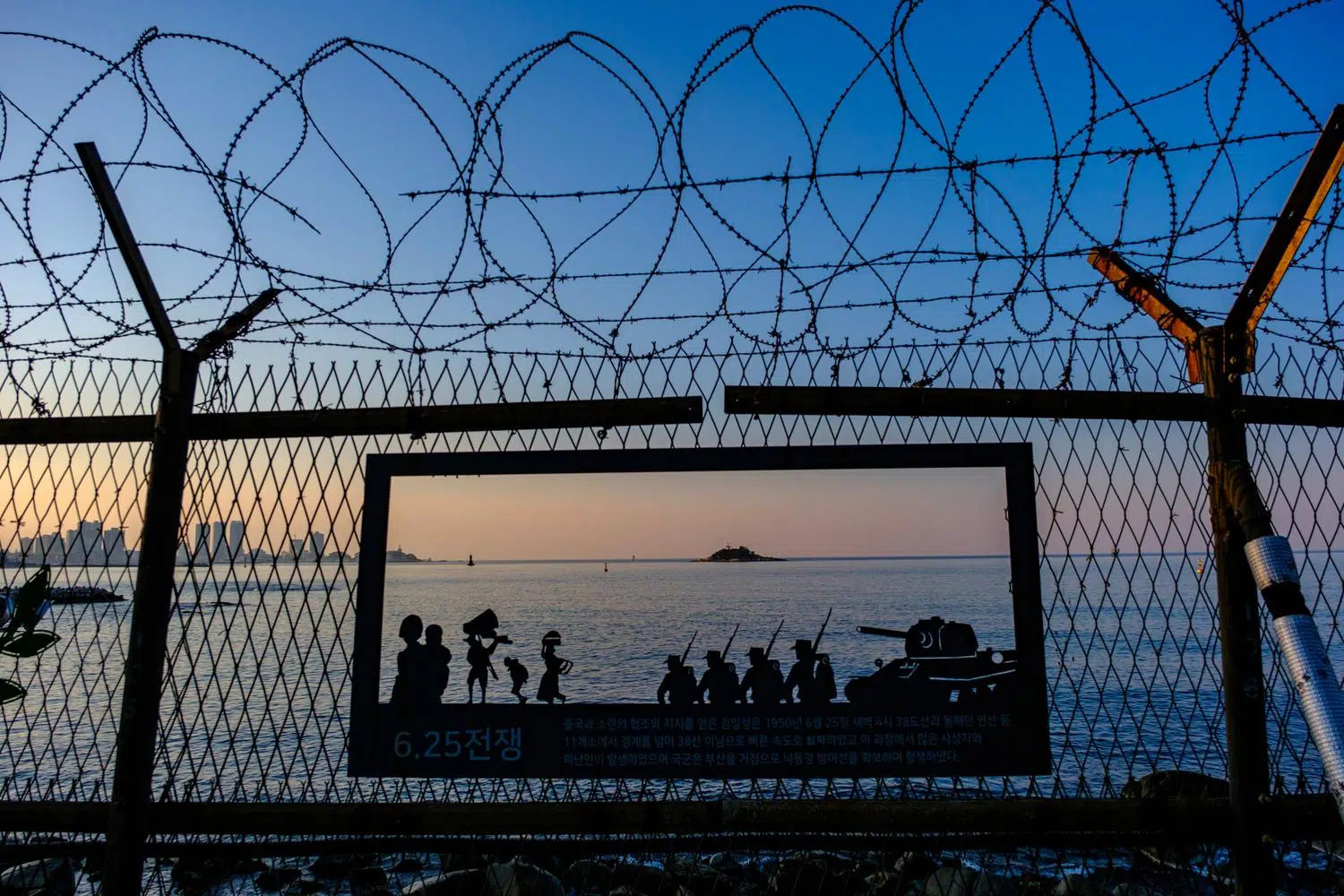 Anti-infiltrator fences and CCTV cameras along a coastal path in the City of Sokcho.